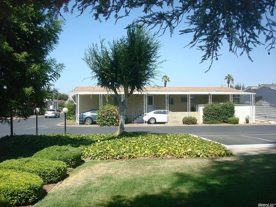Looking North at home from Clubhouse area noting additional parking area.