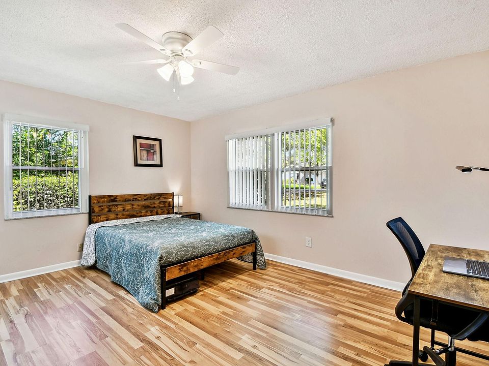 Full size cozy full size bed, with end table, light, desk, office chair and light, storage container under the bed and closet
