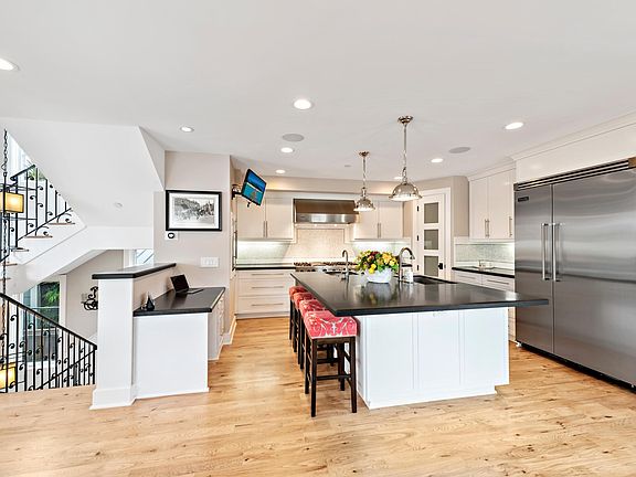 212 Marguerite's state of the art kitchen has a large stone island with bar stools - perfect for spending time with friends and family.