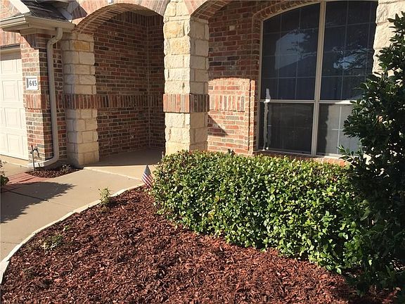 Charming entry with a covered patio big enough for a cafe table or swing to enjoy while looking out over the lovely landscaping.