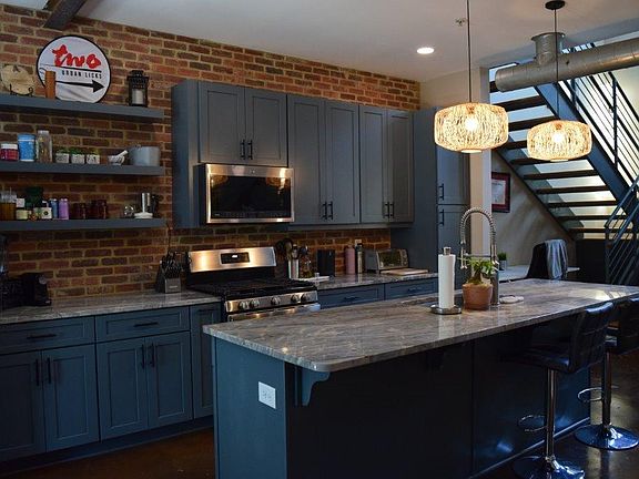 Exposed brick and steel beams add charm to your chef's kitchen.