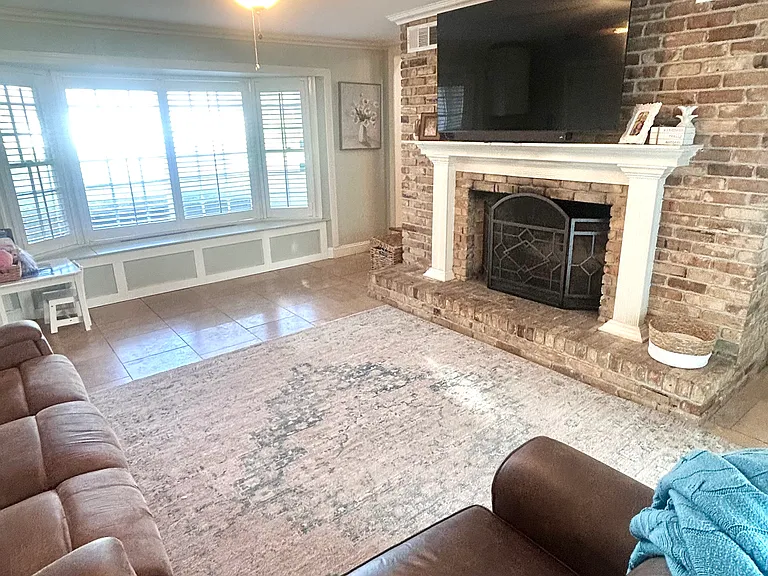 Family room with wood burning fireplace and built in storage
