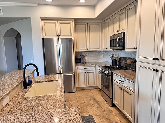 kitchen area with high end stainless steel appliances and brand new Bosch fridge