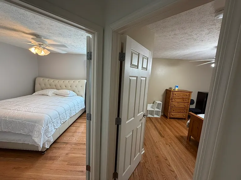 View from the next two bedrooms next to the primary suite. Left is a king bed.
