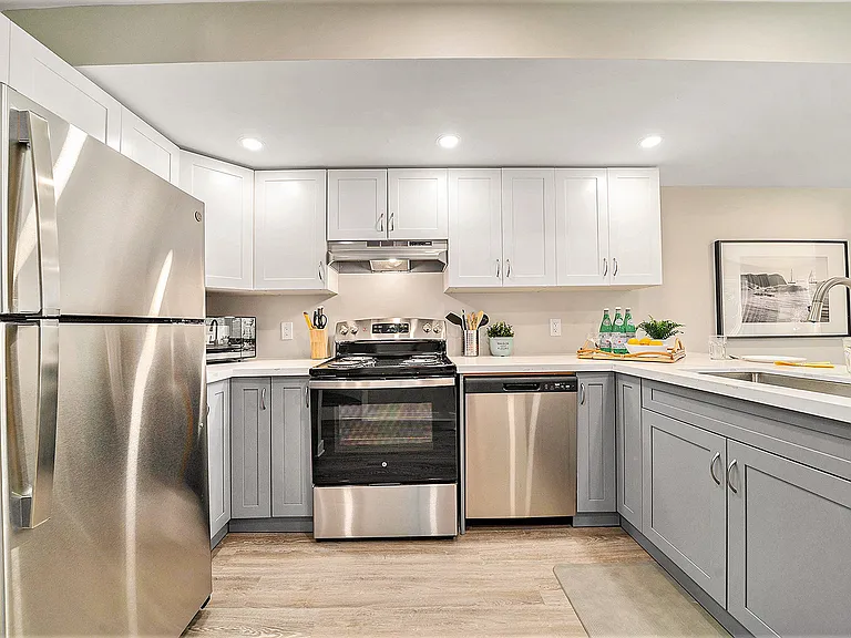 Fully equipped kitchen with stainless steel appliances, perfect for long-term stays in our Ottawa furnished rental.