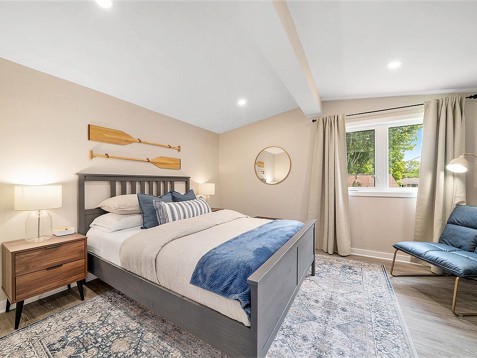 Cozy, modern furnished bedroom in our Ottawa rental, featuring premium linens and ample natural light.