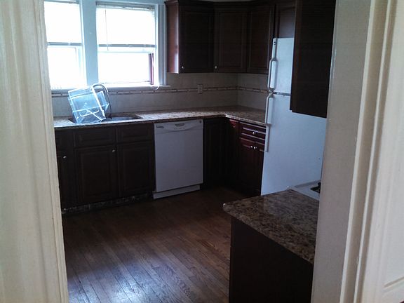 marble countertops, dishwasher, and garbage disposal