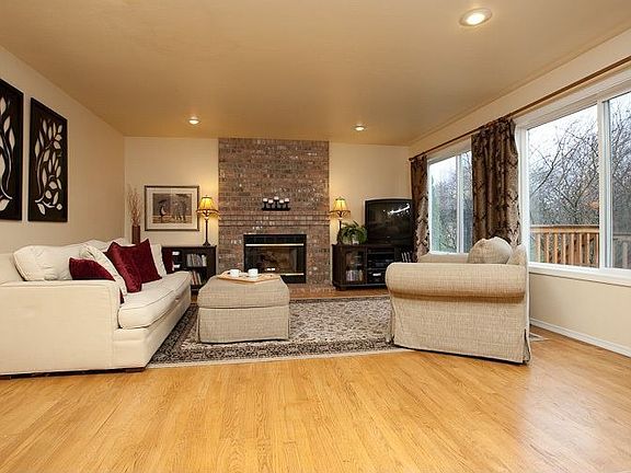 Great room off of kitchen with gas fireplace and access to deck