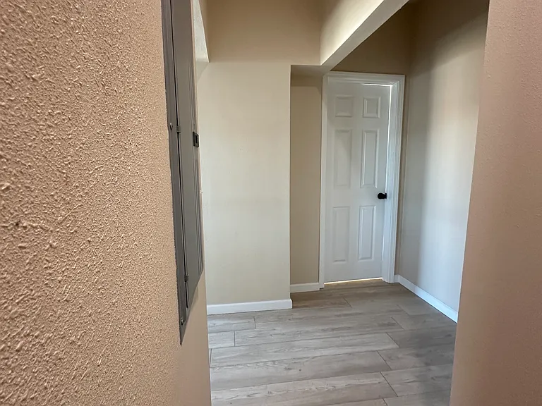 Top of the back stairs. straight ahead is a bedroom to the right is more bedrooms and a bathroom to the left is the kitchen.
