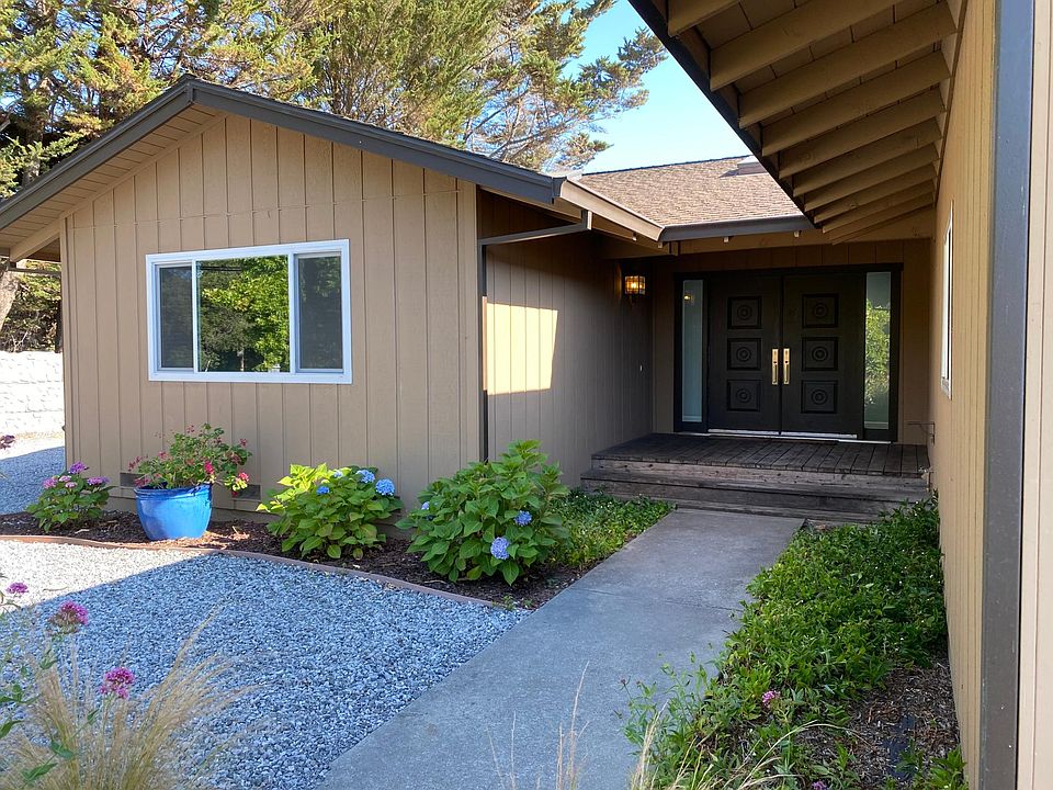 Entryway. Side parking is to the left. Thick concrete walls along Old San Jose Rd for security and privacy.