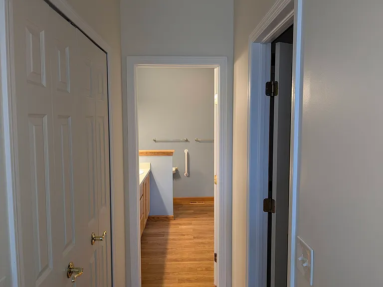 Hall to Master Bath with closets on both sides of Hallway. Closet on right is a walk in closet.
