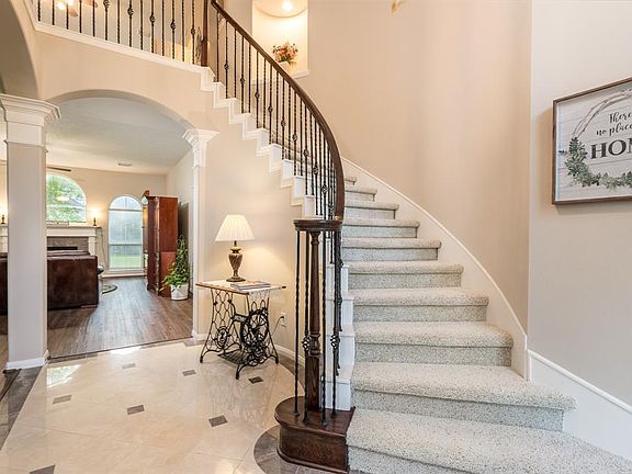 Grand entry welcomes you with sweeping staircase and recently stained banister.