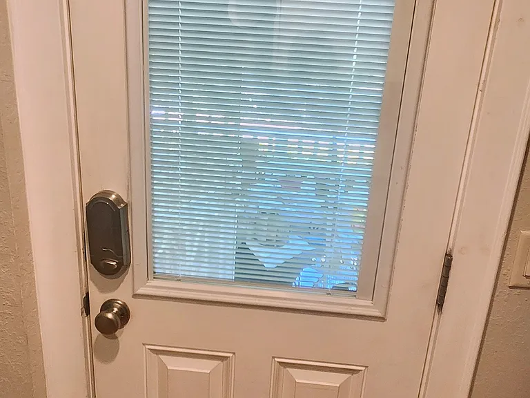 Entry door with adjustable between-the-glass blinds.
