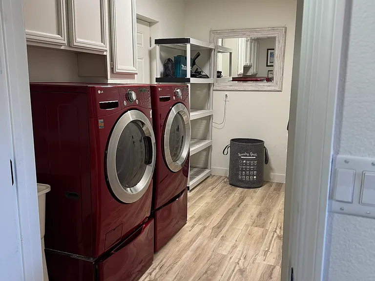 Large laundry area with entrance to garage.