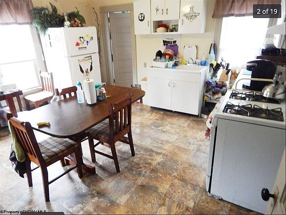 Spacious kitchen with vintage cast iron sink, lots of natural light (all day sun: windows facing east, south, and west)