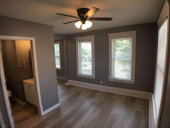 Living room showing doors to bathroom and kitchen