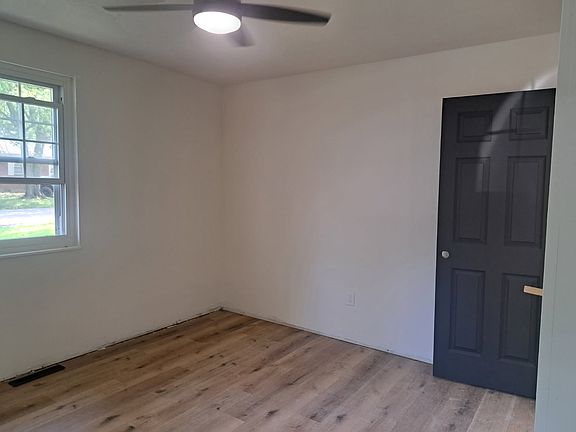 Bedroom #1 with new flooring, ceiling fans with remote, new doors and closet doors