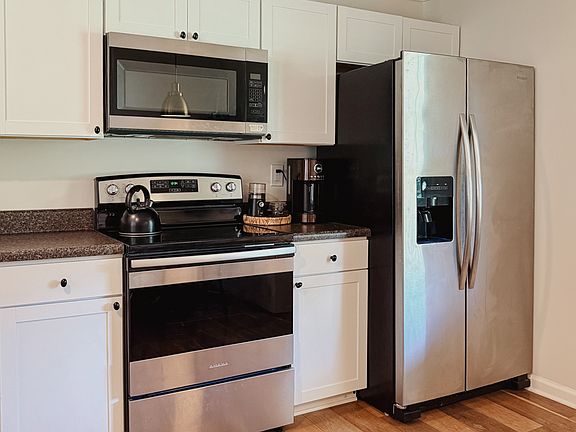 Kitchen is fully stocked with cookware, dishware, utensils, coffee maker, and more