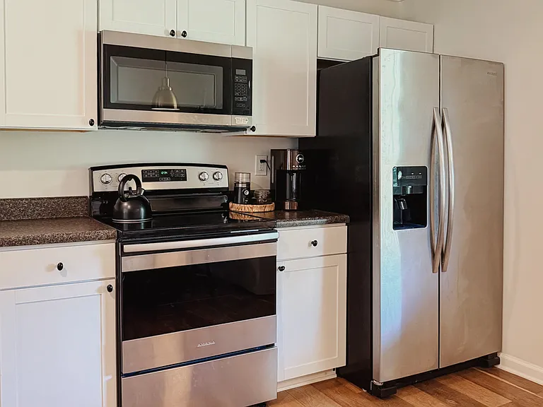 Kitchen is fully stocked with cookware, dishware, utensils, coffee maker, and more