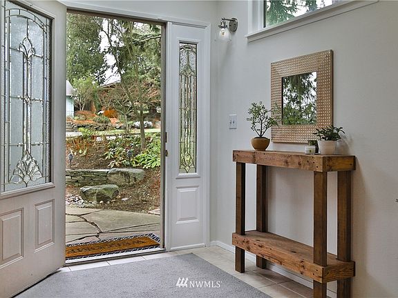 Tiled entry with beveled clear glass panel windows.