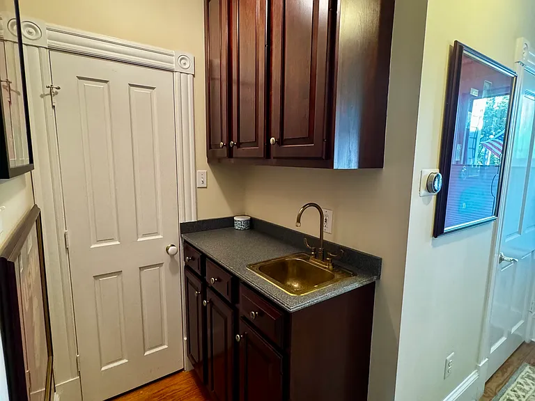 Bar area and coat closet; door on right to main floor bathroom.