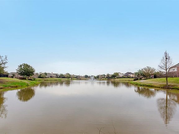 This home enjoys this great view of a lake with fountain and the hike/bike trail is just steps from your front door. What a perfect location!