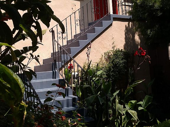 Unit entry from flower filled patio.