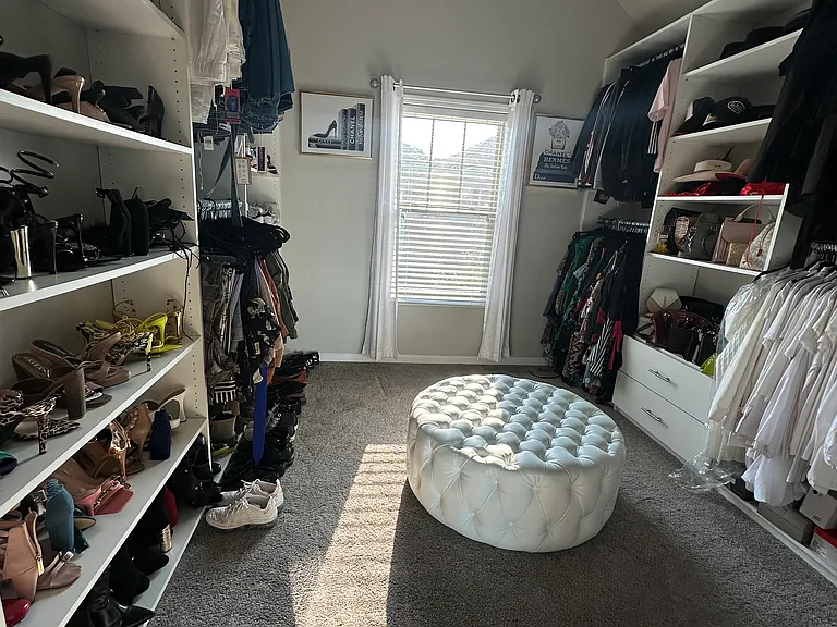 An oversized master closet offering luxury-level storage with room to organize and unwind