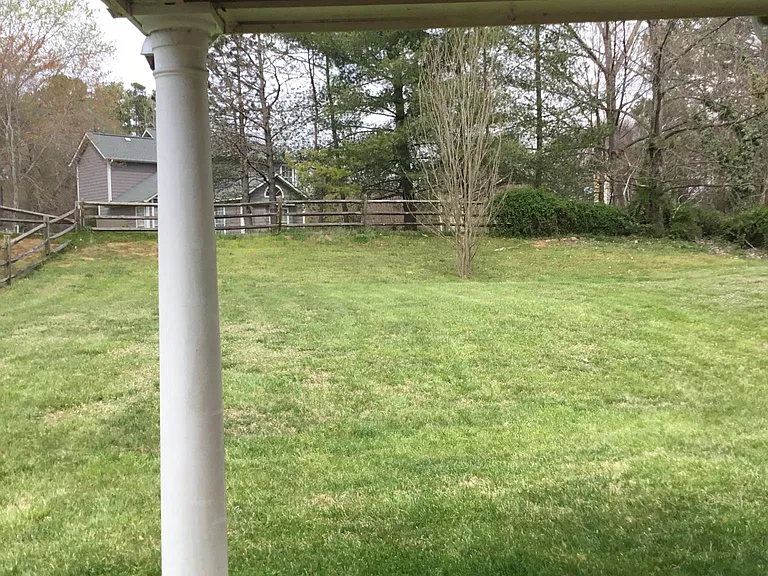 Back patio overlooks large fenced yard