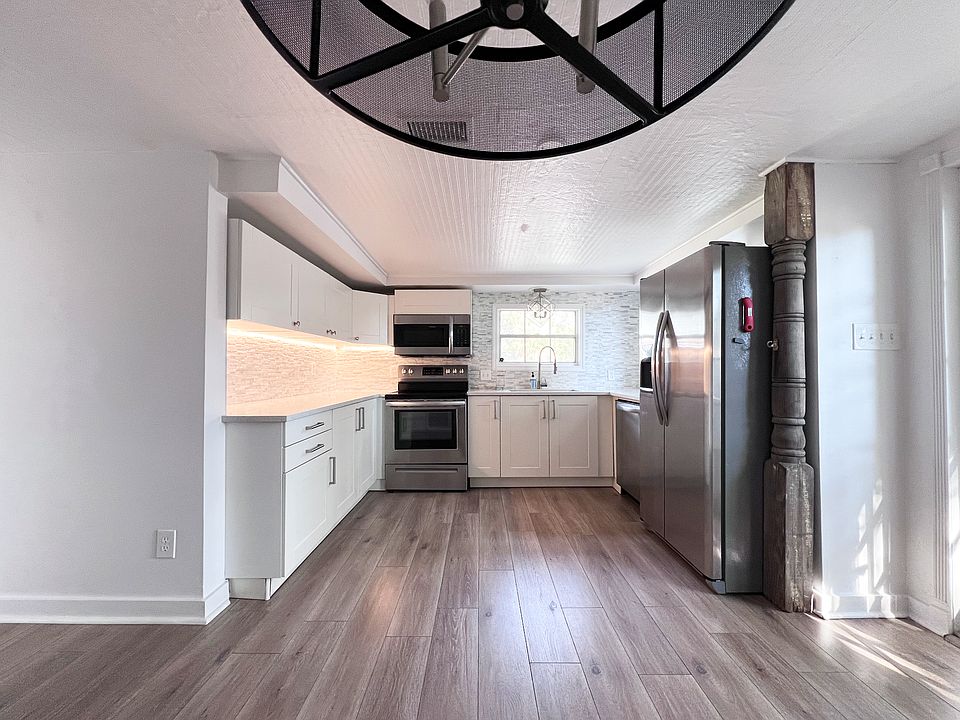 large kitchen with enough room for a 6 person dining table plus island in the middle of the prep area