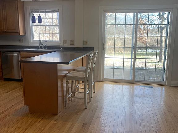 Kitchen with Corian counters and high quality cabinets. Slider door to paver patio.