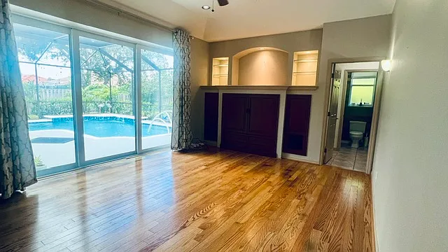 Family room and bedrooms are all hardwood flooring, while the baths and main traffic areas are tile. 
The family room affords room to gather with a maximum tv center of 56". The home is also wired for surround sound if you bring.