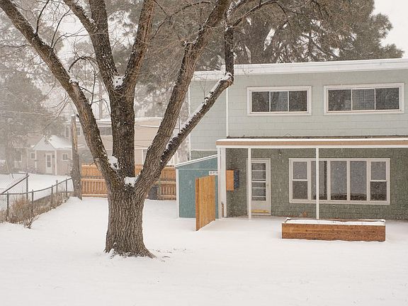 The large back yard has a patio with privacy fencing on both sides. A raised bed is the perfect place to plant flowers or a small garden.