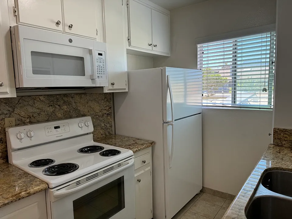 KITCHEN - New microwave, full size appliances, tile flooring granite counter tops and dual sink w/garbage disposal