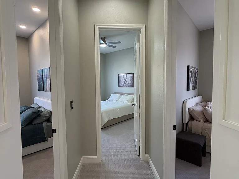 Upstairs hallway featuring three separate bedrooms