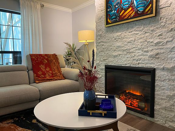 Electric fireplace adds a cozy ambiance to the living room in the winter.