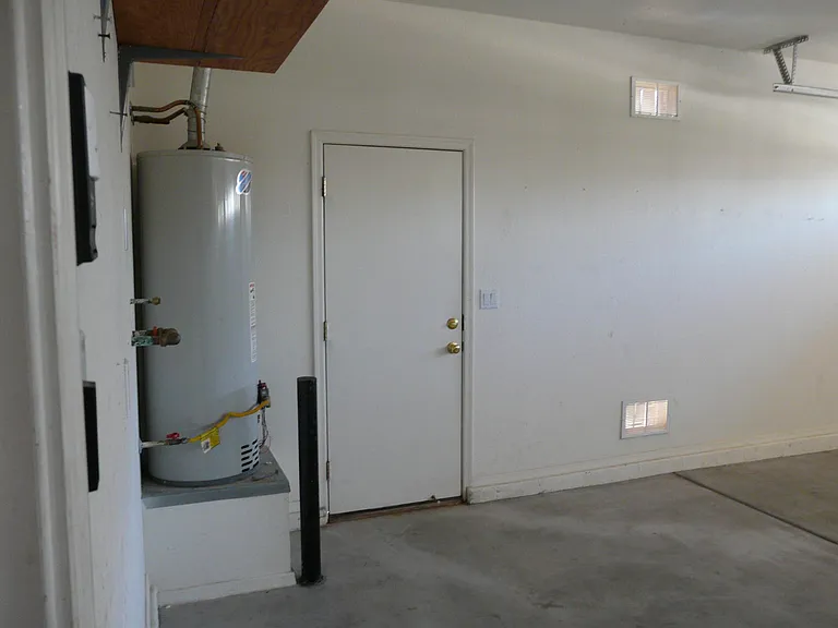 3 car garage ,water heater, water softener hookup and side door to backyard