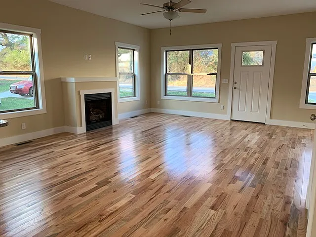 Lots of natural light & windows, mock fireplace add ambience, ceiling fan. - 134 Old County Home Rd
