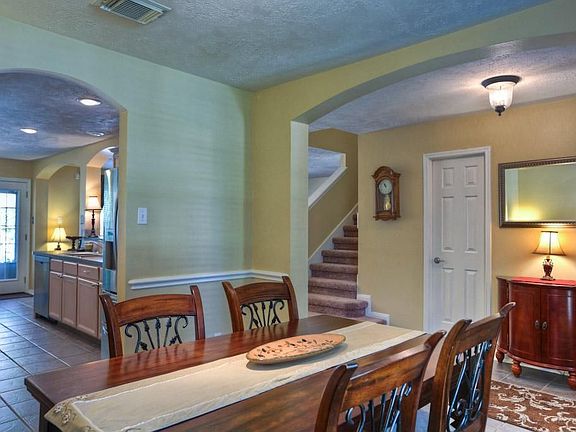 Formal dining room with arched entry to the hall and kitchen.