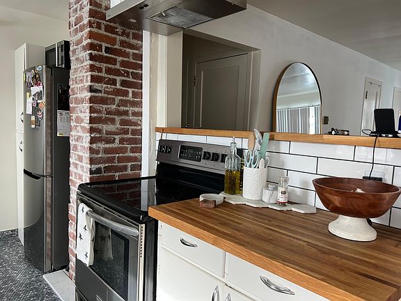 Kitchen: Exposed brick and open kitchen flow