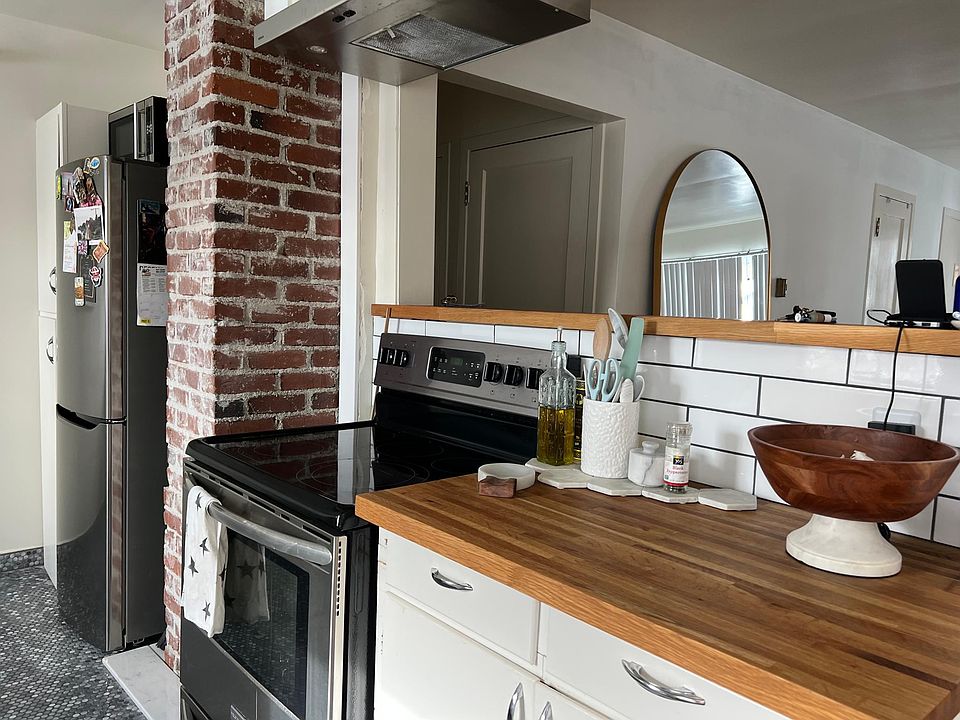 Kitchen: Exposed brick and open kitchen flow