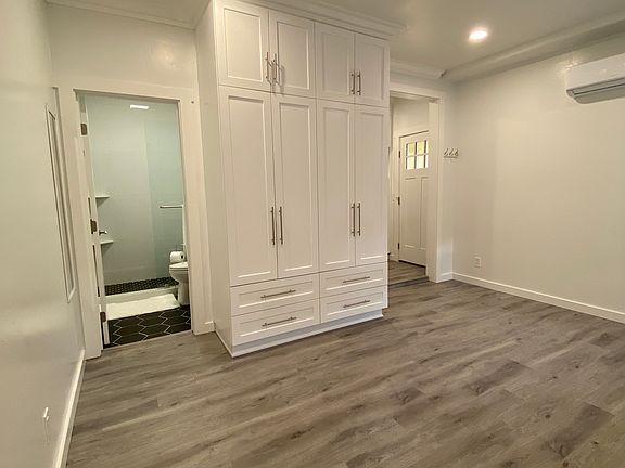 View of the bedroom from the rear wall which shows the custom designed wardrobe closet