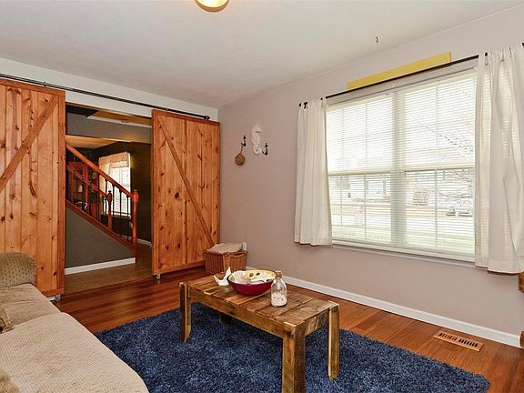 Trendy barn doors adorn the family room entry