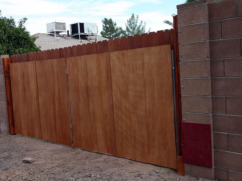 Rear privacy gate as seen from alley behind house.