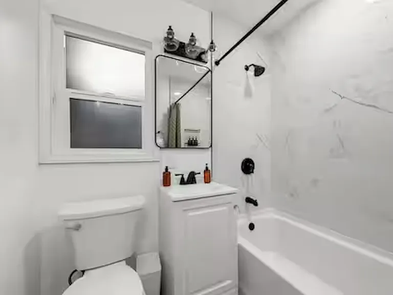 Shared bathroom with a tub/shower combo, thoughtfully designed for comfort and everyday convenience.