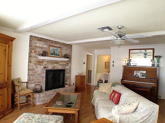 Charming den with wood burning fireplace.