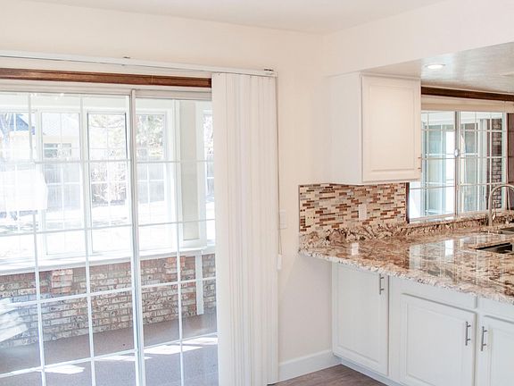Eating area in Kitchen with Breakfast bar showing access to Sunroom/play room