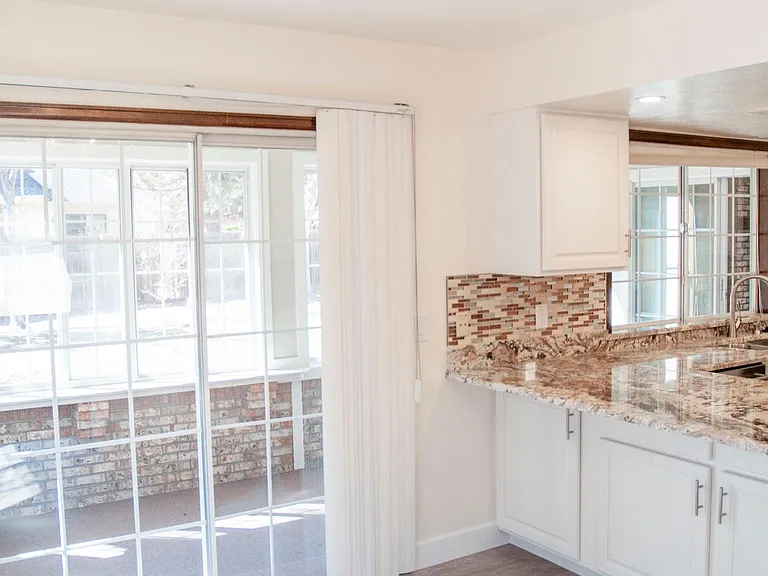 Eating area in Kitchen with Breakfast bar showing access to Sunroom/play room
