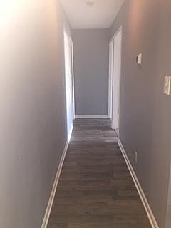 hallway leading to bedrooms and bathrooms