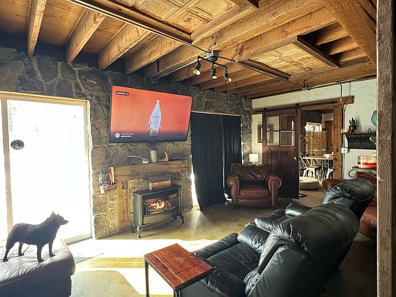 Living room with gas fireplace, large smart tv and views to the waterfron
